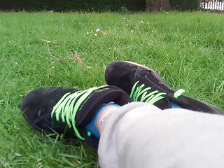 Sie spielt mit ihren blauen socken im Park